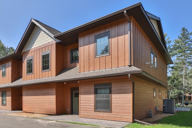 rear view of property with central AC unit