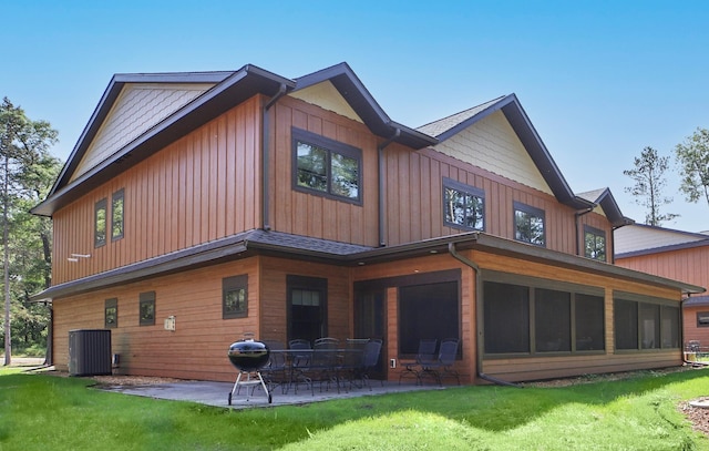 rear view of house with a lawn, a patio, and central air condition unit