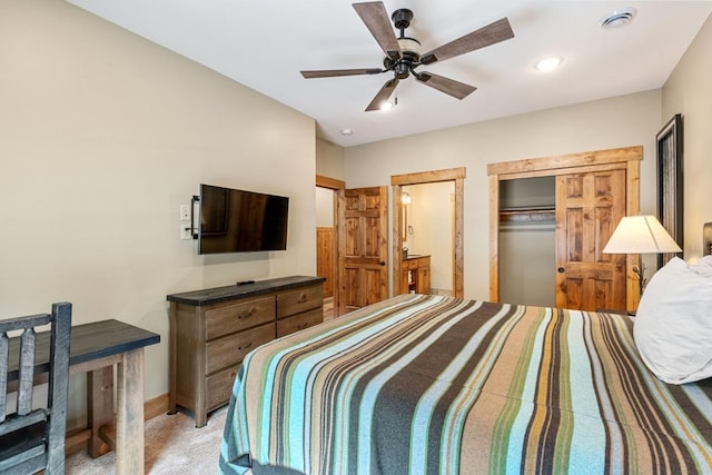 bedroom featuring light colored carpet, baseboards, and a ceiling fan
