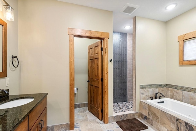 bathroom with vanity, visible vents, a shower stall, stone finish flooring, and a bath