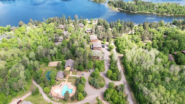 birds eye view of property with a water view, a view of trees, and a residential view
