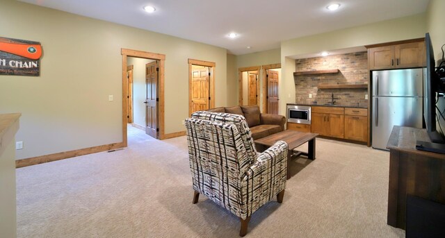 living room with sink and light carpet