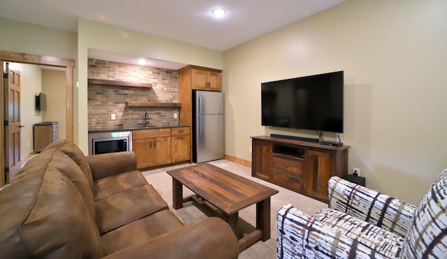 living room with light carpet, wine cooler, and sink