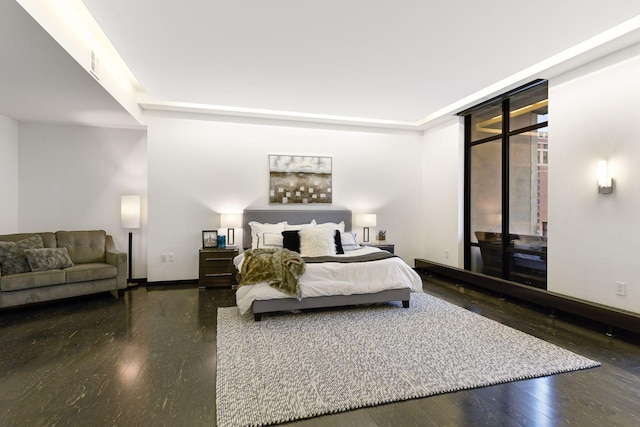 bedroom with expansive windows and dark hardwood / wood-style flooring