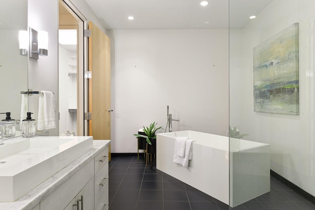 bathroom featuring vanity, a tub, and tile patterned floors