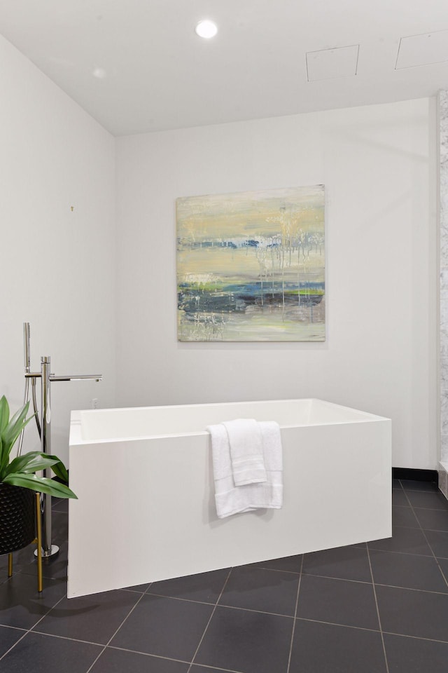 bathroom featuring tile patterned flooring and a washtub