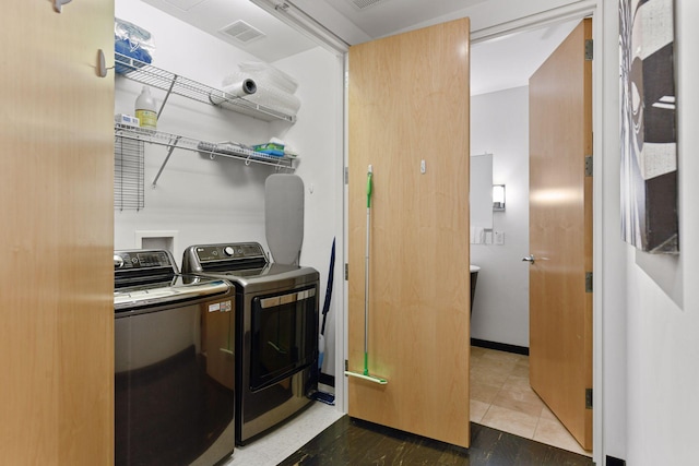 washroom featuring washing machine and clothes dryer and tile patterned flooring