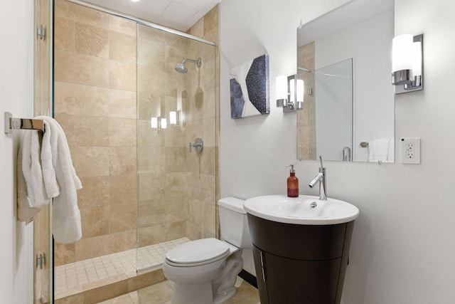 bathroom featuring toilet, a shower with door, and vanity