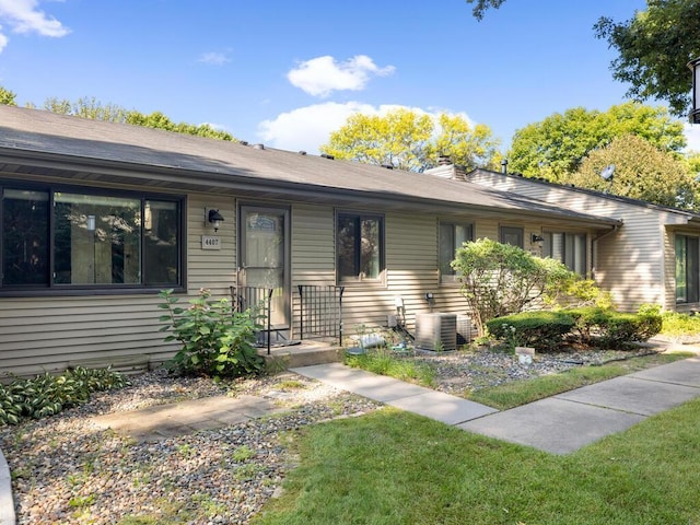 single story home featuring a front lawn and central AC