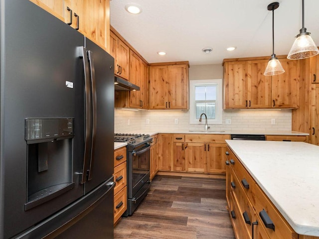 kitchen with fridge with ice dispenser, sink, black range with gas cooktop, decorative light fixtures, and dark hardwood / wood-style floors