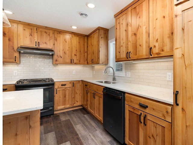 kitchen with dark wood-type flooring, backsplash, sink, and black appliances