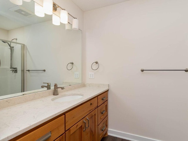 bathroom with vanity and a shower