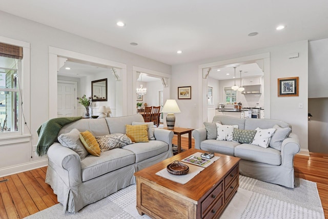 20390 Linwood Rd, Deephaven, MN 55331 - living room featuring light wood-style flooring, a chandelier, and recessed lighting