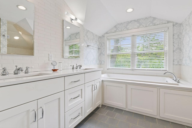 20390 Linwood Rd, Deephaven, MN 55331 - bathroom featuring lofted ceiling, wallpapered walls, double vanity, a garden tub, and tile patterned floors