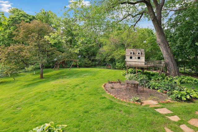 20390 Linwood Rd, Deephaven, MN 55331 - view of green lawn featuring a playground, a deck, and view of scattered trees