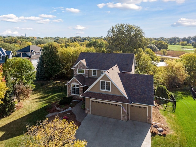 view of front of house with a garage and a front yard