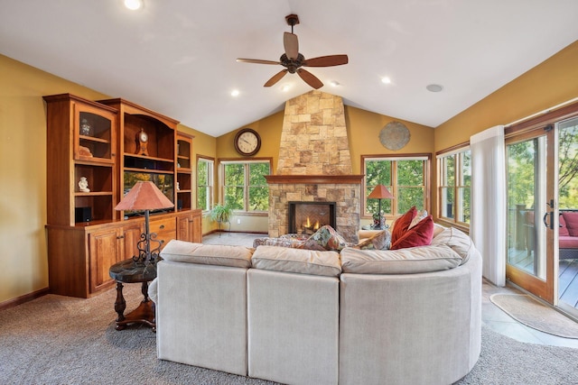 living room featuring a healthy amount of sunlight, a fireplace, and vaulted ceiling