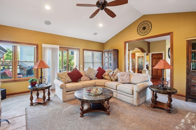 carpeted living room featuring ceiling fan, vaulted ceiling, and decorative columns