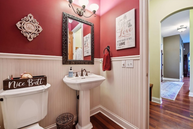 bathroom with hardwood / wood-style flooring, toilet, and sink