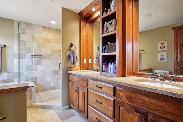 bathroom with vanity, a shower with shower door, and tile patterned flooring