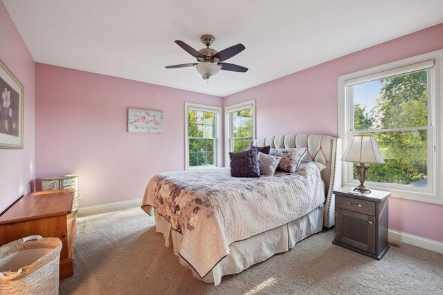 bedroom featuring light carpet and ceiling fan