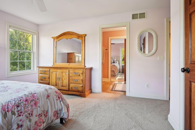 bedroom with ceiling fan and light carpet