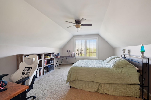 carpeted bedroom with ceiling fan and vaulted ceiling