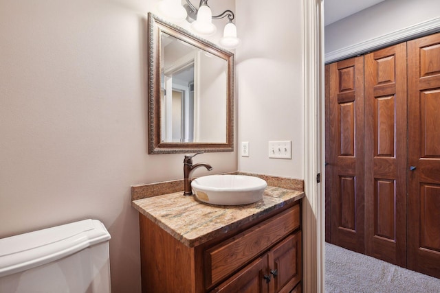 bathroom featuring vanity and toilet