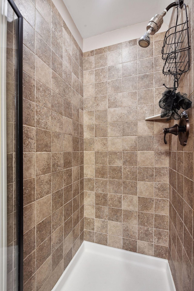 bathroom with a tile shower