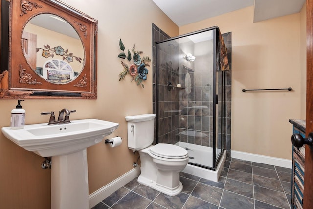 bathroom featuring tile patterned floors, toilet, an enclosed shower, and sink