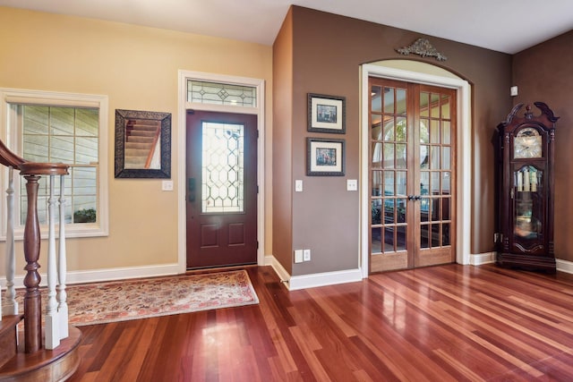 entryway with french doors, wood finished floors, baseboards, and a wealth of natural light