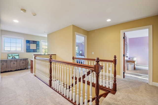 corridor with an upstairs landing, carpet flooring, recessed lighting, and baseboards