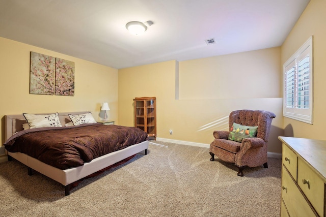 bedroom with carpet flooring, baseboards, and visible vents