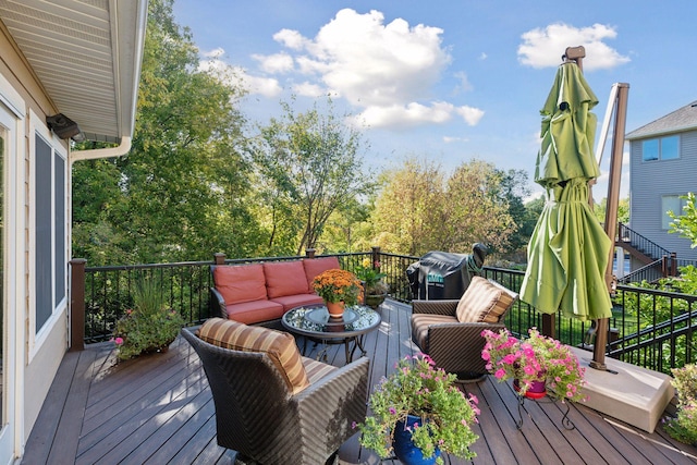 wooden deck featuring an outdoor living space and a grill