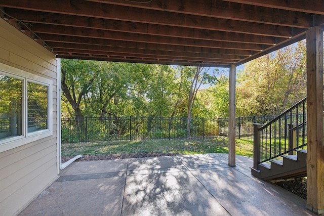 view of patio with stairway and a fenced backyard