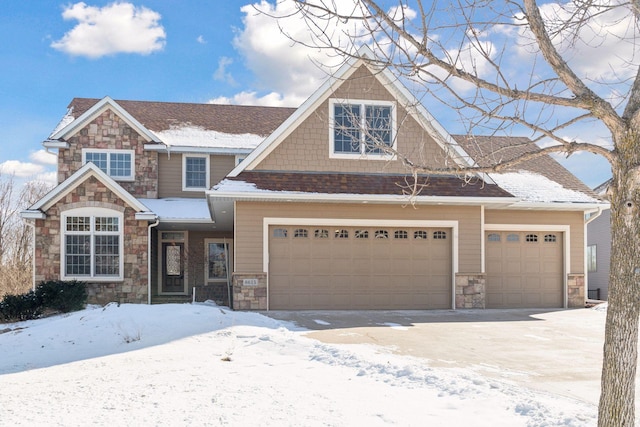 view of front facade featuring a garage and stone siding