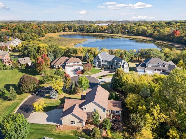 birds eye view of property featuring a residential view, a water view, and a view of trees