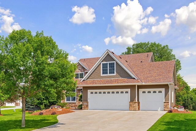 8615 Kelzer Pond Dr, Victoria, MN 55386 - view of front of property featuring driveway, stone siding, and a front yard