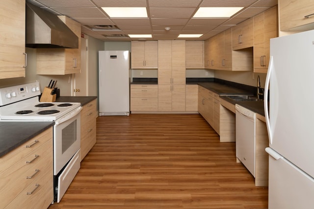 kitchen featuring sink, range hood, light hardwood / wood-style flooring, white appliances, and light brown cabinetry