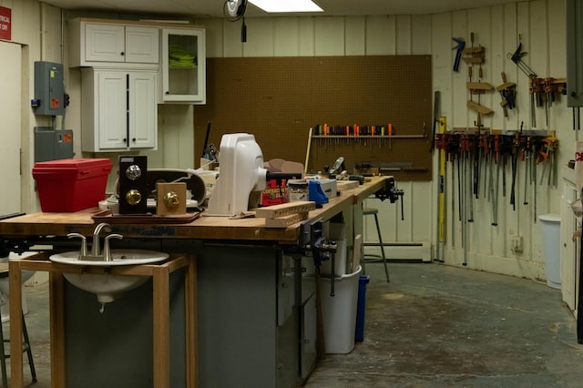 kitchen featuring a baseboard heating unit and white cabinets