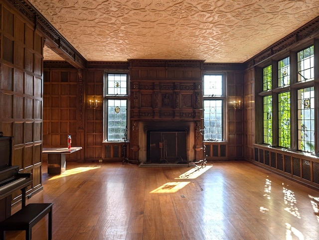 unfurnished living room featuring wood walls and hardwood / wood-style flooring