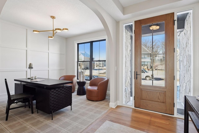 foyer entrance featuring an inviting chandelier and hardwood / wood-style flooring