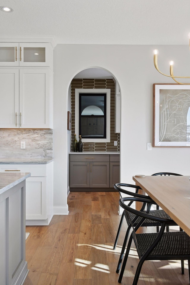 dining space with light hardwood / wood-style flooring and sink