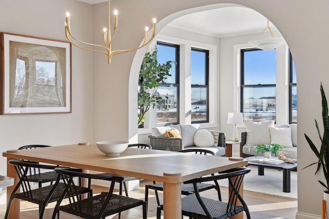 dining area featuring light hardwood / wood-style floors and a notable chandelier