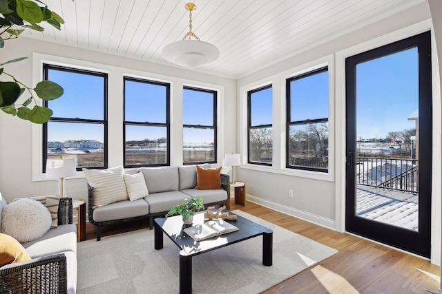 living room with wooden ceiling, light hardwood / wood-style floors, and plenty of natural light