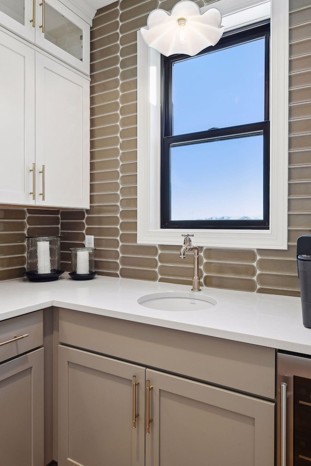 bathroom featuring beverage cooler, tasteful backsplash, and vanity