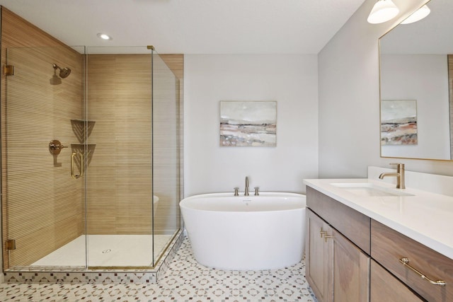 bathroom with tile patterned floors, vanity, and shower with separate bathtub