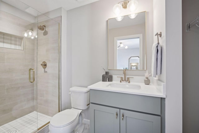 bathroom with an enclosed shower, vanity, and toilet