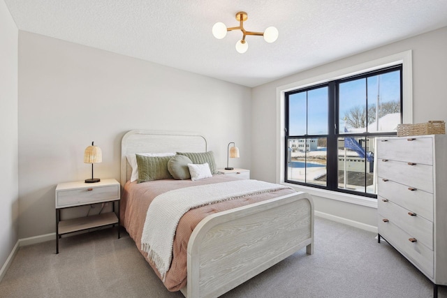 carpeted bedroom featuring a textured ceiling