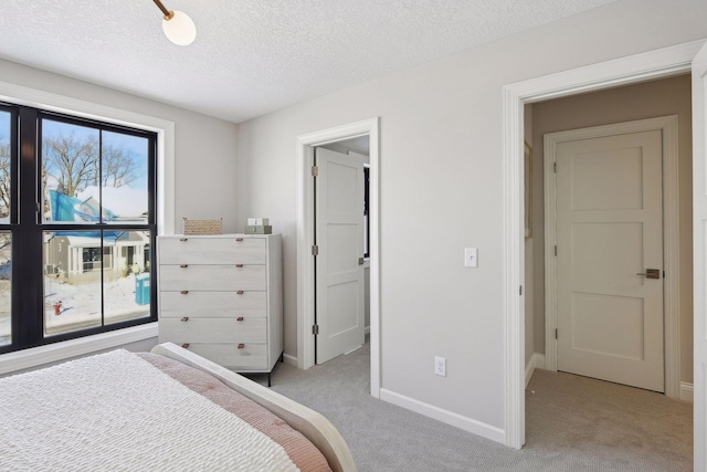 bedroom featuring light colored carpet and a textured ceiling